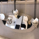 Stort hjartesmykke med diverse tekstar